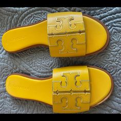 Tory Burch's Ines Slides Are Crafted Of Fine Leather With A Cushioned Footbed For Comfort. These Slides Are A Single-Band Style With A Signature Double T Logo Applique. The Goldfinch Color Is A Deeper Yellow Color With The Double T Logo Outlined In Metallic Gold. Brand New In Box. Never Worn. Size Women’s: Us 8 Color: Goldfinch/Gold Metallic Vegan Leather Open Toe Slip-On Rubber Sole Duster Bag Included The Goldfinch, T Logo, Goldfinch, Tory Burch Shoes, Gold Yellow, Metallic Gold, Yellow Color, Women's Shoes Sandals, Open Toe