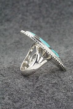 This turquoise and sterling silver ring was made by Navajo silversmith Andrew Vandever. The back is partially stamped R.B. and .925.Size: 7.5Length: 1 5/8"Width: 3/4"Free shipping on all orders! We ship with USPS and always include tracking. All orders ship within a day of payment.Returns are accepted up to 30 days after you receive your order. Just send us a message. Our shop offers cash back or store credit. The item must be returned in new condition. Western Silver Turquoise Ring Stamped 925, Western Style Sterling Silver Turquoise Inlay Ring, Western Style Turquoise Ring With Sterling Silver Inlay, Western Style Turquoise Inlay Ring In Sterling Silver, Southwestern Silver Turquoise Open Ring, Southwestern Style Silver Open Turquoise Ring, Southwestern Style Silver Turquoise Open Ring, Southwestern Open Turquoise Ring, Turquoise Sterling Silver