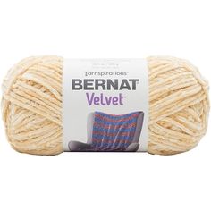 bernat velvet yarn in beige and blue colors on a white background with the words bernat velvet written above it