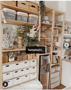 a kitchen filled with lots of wooden shelves