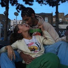 a man kissing a woman on the cheek