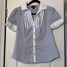 Banana Republic Pinstripe Blue And White Blouse. Ruffles At Chest, Gorgeous Navy Metal Buttons. Size Small Super Cute & Professional! Tiny Smudge On L Sleeve (See Picture) Likely Easily Washed Out! 100% Cotton, Hand Wash Cold Only Never Worn Blue Blouse With Striped Collar And Short Sleeves, Vertical Stripes Summer Office Tops, Short Sleeve Vertical Stripes Blouse For Work, Elegant Striped Short Sleeve Shirt, Short Sleeve Vertical Stripe Workwear Blouse, Striped Cotton Blouse For Office, Elegant White Blouse With Vertical Stripes, White Vertical Striped Tops For Office, Fitted Vertical Stripes Office Tops