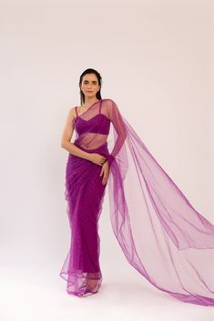 Featuring a burgundy pre-stitched saree in net base. It is paired with a strappy bandeau blouse. Color: BURGUNDY FABRIC: NET Delivery time 15 to 20 days Glamorous Organza Pre-draped Saree, Fitted Net Pre-draped Saree For Reception, Festive Sheer Saree, Party Net Pre-draped Saree, Purple Bollywood Party Pre-draped Saree, Festive Fitted Sheer Sets, Fitted Organza Pre-draped Saree For Designer Wear, Evening Fitted Organza Saree, Designer Purple Pre-draped Saree With Sheer Dupatta