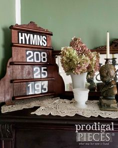 a vase with flowers on top of a table next to a sign that reads hymps