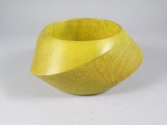 "A classic by Gerda Lynggaard.  Although unsigned, this wood bangle is a signature -- and very popular -- piece of hers.  It's constructed from a lightweight wood featuring angled, graduated swirling planes, here in a HTF yellow finish.  The bracelet is in excellent vintage condition with only a hint of wear.  There's no finish loss, dings, chips or other damage to note.  It will make a fine addition to any serious Gerda Lynggaard Monies jewelry collection. Width (measured on interior) 2\".  Interior circumference 8\"" Monika Ettlin Jewelry, 60s Bracelets, Antique Yellow Collectible Jewelry, 1960s Bracelet, Monies Jewelry, Vintage Orange Bangle Bracelets, Beautiful Belts, Bangle Bracelet, Statement Jewelry