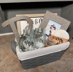 a basket filled with mason jars and personalized items