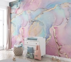 a baby's room with pink, blue and gold marble wallpaper on the walls