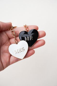 two heart shaped key chains with the word mr and mrs on them