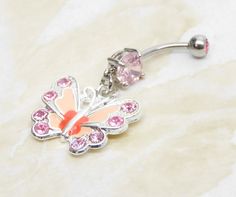 14g surgical steel belly ring with with pink crystal gem and matching pink enameled butterfly charm. Belly ring measures 1 7/8 inches long total length. Barbell is 14g standard surgical steel with a 10mm wearable bar length. Top ball measures 5mm, bottom ball measure 8mm. ** To keep the rhinestones looking their best I do not recommend you wear while swimming or bathing. For Belly Button Rings: https://www.etsy.com/shop/AllAboutClass?section_id=18474235&ref=shopsection_leftnav_1 All body jew Pink Stainless Steel Jewelry With Charms, Pink Metal Jewelry With Butterfly Charm, Pink Internally Threaded Belly Rings As Gift, Pink Dangle Belly Rings For Gift, Pink Dangle Belly Rings As Gift, Pink Dangle Jewelry With Butterfly Charm, Pink Butterfly Charm Dangle Jewelry, Adjustable Pink Body Jewelry For Gift, Nickel-free Pink Belly Rings As Gift