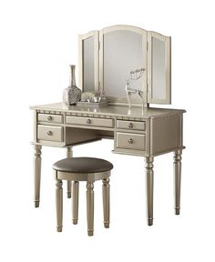 an antique vanity with stool and mirror