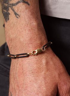 Very unique, super elongated (23mm) oval cable links attached to each other with minimalist 14k Gold Filled Rounded links. For the "everything black" style fellas, this bracelet is a super cool addition to your wardrobe. With the very slight but VERY intentional pop of gold. Material: 925 Sterling Silver with Titanium plating for the black oval links and 14K Gold Filled (smaller links and clasp) Bracelet Width: 6mm Clasp: Lobster Claw Available in 7, 8, 9 inches. If you need a custom or in-betwe Modern Black Chain Link Jewelry, Classic Black Link Jewelry, Modern Black Oval Link Jewelry, Black Oval Link Cable Chain Jewelry, Black Jewelry With Oval Link Cable Chain, Classic Black Chain Bracelet For Everyday, Minimalist Black Link Chain Bracelet, Black Chain Link Jewelry For Everyday, Black Chain Link Bracelets For Everyday