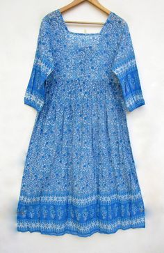 "ITEM DESCRIPTION summer blue flower printed cotton long maxi dress - square neckline with back tassel maxi dress - 3/4th sleeve maxi dress Features: 3/4th sleeve, square neck, Long dress Material: Cotton Voile Fabric: 100% cotton soft light weight ethnic print fabrics  Sleeve Length = 18 inch For more sizes & their measurement, please refer our below chart to understand the sizes variations available with us For your size requirement, please mention your size in seller note at the time of buyin Blue Half-sleeve Maxi Dress For Vacation, Blue 3/4 Sleeve Maxi Dress For Beach, Bohemian Light Blue Cotton Maxi Dress, Bohemian Flowy Half Sleeve Maxi Dress, Bohemian Flowy Maxi Dress With Half Sleeves, Long Blue Floral Print Boho Dress, Bohemian Half Sleeve Flowy Maxi Dress, Blue Long Boho Print Dress, Long Blue Boho Print Dress