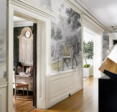 a room with a wallpapered mural and wooden flooring in the foreground