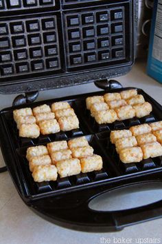 some food that is sitting on top of a waffle maker and it looks like they have tofu cubes in them