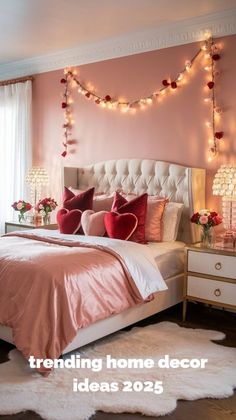 a bedroom decorated in pink and white with lights