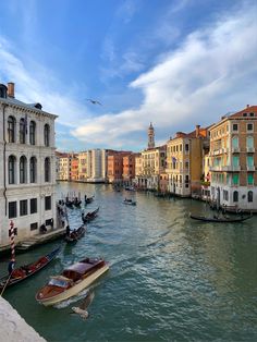 several boats are docked in the water next to buildings