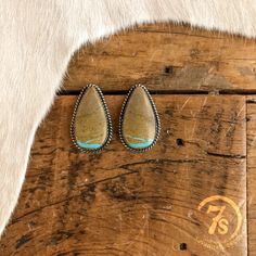 Statement handmade turquoise earrings. Boulder turquoise stones each unique in color variation and veining. Sterling silver setting. Rope trim detail. Post back. Navajo handmade. National Finals Rodeo