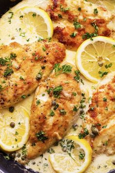 chicken with lemons and herbs in a skillet