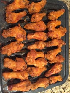 chicken wings on a baking sheet ready to be cooked in the oven for dinner time