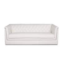 a white couch sitting on top of a white floor