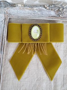 Chartreuse green bowtie, Velvet ribbon bow brooch, Modern brooch, Lime green, Everyday fashion, OOAK Beautiful gift for girlfriend, women, wife, mother or daughter on Christmas or any other occasion. This handmade bow tie can be worn on a shirt, a dress, a sweater, a t-shirt or as an accessory for coat, bag or everything is allowed to be attached by a brooch  4 inch lengths 4 inch width Ready for shipping My Flower accessories are carefully packed in a sturdy box for shipping to make sure they a Elegant Green Pins For Gifts, Vintage Bow Tie Brooch As Gift, Elegant Bow Tie Brooches For Gift, Elegant Bow Tie Brooch For Gift, Elegant Yellow Brooches For Party, Elegant Yellow Party Brooches, Elegant Yellow Party Brooch, Vintage Ribbon Brooches For Formal Occasions, Vintage Ribbon Brooches As Gift