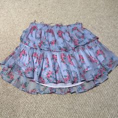 Beautiful Lsf Skirt Worn Once. Perfect Condition With No Stains, Blemishes, Or Flaws. Size Xs Fits True To Size. The Best Selling Ruffle Mini Skirt Returns For The Season With A Vibrant Floral. She Features Intricate Inset Lace Trims And Allover Pintuck Details. The Elasticated Waistband And Double Lining Offers Flexibility In Comfort And Styling. Tiered Ruffles Exude Effortless Femininity. The Mini Is Finished With A Frayed, Raw Hem For Added Playfulness. 100% Cotton. Hand Wash, Cold Water Only, Cool Iron. Flowy Purple Mini Skirt With Ruffles, Chic Purple Ruffled Mini Skirt, Chic Purple Mini Skirt With Ruffles, Purple Tiered Ruffled Skirt, Purple Tiered Skirt For Spring, Feminine Purple Summer Skirt, Purple Ruffled Mini Skirt For Summer, Summer Purple Ruffled Mini Skirt, Summer Tiered Mini Skirt In Purple