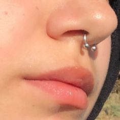 a close up of a person with a nose piercing