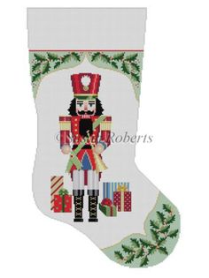 a cross stitch christmas stocking with a nutcracker