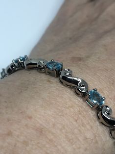 This Blue Topaz bracelet is very lively and bright. The stones are deep colors and well matched. The sterling silver is very solid with antiqued rhodium finish 7.5 inches My jeweler can shorten this for a $20 fee All jewelry is shipped in a nice gift box. Check out our over a THOUSAND great reviews Engraving is $4 per letter and is not always perfect depending on the piece. It can take a few days if the jeweler is busy. This is payable to Paypal Judithsltd@gmail.com Topaz Bracelet, Silver Tennis Bracelet, Blue Topaz Bracelet, Blue Jewelry, Vintage Jewels, Deep Colors, Vintage Bracelets, Tennis Bracelet, Chain Link Bracelet