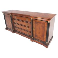 a large wooden dresser with brass trimmings and drawers on one side, in the shape of a chest of drawers