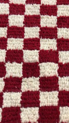 red and white crocheted blanket with checkerboard pattern on the bottom side