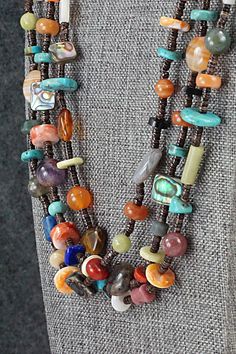 This three-strand turquoise, coral, lapis, amber, spiny oyster, mother of pearl, abalone, jasper, onyx, amethyst and sterling silver necklace was made by Navajo artisan Helen Tsosie.Necklace: 29" with an additional 2" extender chainWidth: 1/8" to 1/2"Free shipping on all orders! We ship with USPS and always include tracking. All orders ship within a day of payment.Returns are accepted up to 30 days after you receive your order. Just send us a message. Our shop offers cash back or store credit. The item must be returned in new condition. Bear Carving, Spiny Oyster, Pearl Chain, Multi Stone, Sterling Silver Necklace, Sterling Silver Necklaces, White Vintage, Mother Of Pearl, Onyx