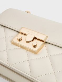 This product is made with at least 20% sustainable materials by weight. CHARLES & KEITH uses recycled, degradable, organic, and water-based materials in our eco-conscious collection. Exuding timeless elegance, this bag is destined to be a staple this season and beyond. The sleek ivory quilted finish, while understated, adds intriguing texture that elevates the classic front-flap style. Minimal gold-toned hardware imparts a luxurious quality, with the eye-catching push-lock closure ensuring both style and security for your essentials. Finished with a sophisticated chain strap, this bag will effortlessly elevate even your most casual, off-duty looks. Minimal Gold, How To Finish A Quilt, Charles Keith, Sustainable Materials, Eco Conscious, Off Duty, Chain Strap, Timeless Elegance, Sleek