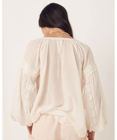 Elegant and sweet, our Magnolia Blouse features intricate details of micro ruffles, lace trims and tassels all crafted on the softest organic cotton. Pair this back with your favourite denim or dress it up with a statement skirt and jewels to take this baby from day to night. Crafted from our preferred fibre 100% organic cotton Shell buttons down front allowing it to be worn as a blouse or open as a shirt Unlined for easy wear 100% Organic Cotton Elasticated Sleeve Cuff Neck Ties Raglan Sleeve P Long Sleeve Bohemian Tops For Gatherings, Cotton Ruffle Blouse For Gatherings, Summer Cotton Lace Top With Lace Sleeves, Bohemian Blouse With Ruffles For Gatherings, Peasant Cotton Blouse For Gatherings, Peasant Style Cotton Blouse For Gatherings, Chic Cotton Lace Summer Tops, Chic Cotton Lace Tops For Summer, Bohemian Cotton Tops With Lace Trim