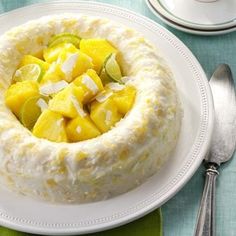 a white plate topped with a cake covered in pineapple and cucumber slices