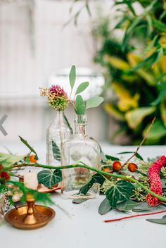 the table is set up with flowers and candles for an outdoor wedding reception or bridal party