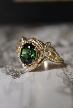 ✵ Learn more about us: www.edengardenjewelry.com ✵ E-mail: info@edengardenjewelry.com This listing is for engagement ring only. Complete Lida tourmaline engagement ring set is available: https://www.etsy.com/listing/1207513156/green-tourmaline-engagement-ring-set This is an upgraded version of our Lida engagement ring. Art nouveau inspired  engagement ring features sophisticated style and timeless look. Oval cut central gemstone is surrounded by stylised flowers and adorned with sparkling diamon Yellow Gold Oval Engagement Ring, Fantasy Engagement Ring, Gold Oval Engagement Ring, Engagement Ring Nature, Stylised Flowers, Tourmaline Engagement Ring, Ethical Engagement Ring, Green Tourmaline Ring, Oval Engagement Ring