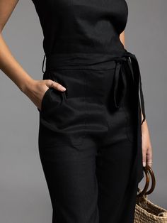 Style Description: Jumpsuit Crew neckline Tie waist detail Measurements for a size small: Chest: 17" Rise: 11" Inseam: 24.5" Fabric Content/Care: 52% Linen 46% Rayon 2% Spandex Machine Wash ColdImport Black Overall Jumpsuits And Rompers With Pockets, Black High Waist Jumpsuits And Rompers With Pockets, Black High-waist Jumpsuits And Rompers With Pockets, Chic High Waist Overalls For Work, Chic Black Overalls For Spring, Black Summer Overalls For Workwear, Black Summer Workwear Overalls, High Waist Jumpsuits And Rompers For Work With Pockets, High-waist Jumpsuits And Rompers For Work With Pockets