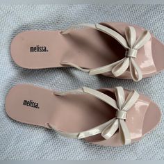 New Melissa Ela Sandals In Pink With Beige Bow. Lightly Padded Footbed, Close Toe Construction Elevates The Casual Flip Flop Style. Worn Once To Try On, But Never Worn Out. Us Size 8 Eur 39 Pink Synthetic Flat Heel Flip Flops, Pink Slip-on Jelly Sandals For Summer, Casual Pink Slip-on Jelly Sandals, Pink Slip-on Jelly Sandals For The Beach, Pink Synthetic Slip-on Jelly Sandals, Trendy Pink Slip-on Jelly Sandals, Pink Closed Toe Synthetic Jelly Sandals, Pink Casual Flat Jelly Sandals, Feminine Pink Flat Heel Sandals