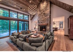 a large living room with couches and a fireplace