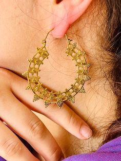 These golden brass earrings are inspired by traditional Indian art. Resembling ritual and spiritual symbols such as lotus flower and mandalas, they add charm to the lady who wears them. Perfect for boho chic looks, these earrings are unusual but elegant and stylish and it makes these earrings a real eye-catcher. Brass is a composition of copper and zinc and therefore it does not cause any nickel related allergy. Sold in pairs. Brass is a metal that oxidizes over time but it is very easy to make it shine again with a soft cloth and toothpaste or lemon or any copper/brass metal cleaning product. If you like the aged effect, you can leave them oxidised.  A perfect gift for every woman! Intricate Brass Drop Earrings Danglers, Festive Brass Hoop Earrings With Intricate Design, Intricate Brass Drop Danglers, Bohemian Brass Chandbalis For Festive Occasions, Brass Danglers With Intricate Design, Brass Temple Jewelry Earrings For Rituals, Festive Brass Plug Earrings, Brass Temple Jewelry Chandelier Earrings For Festivals, Brass Chandbalis With Intricate Design For Gift