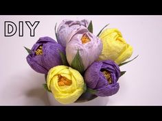 purple and yellow flowers in a white vase with the words diy written on it