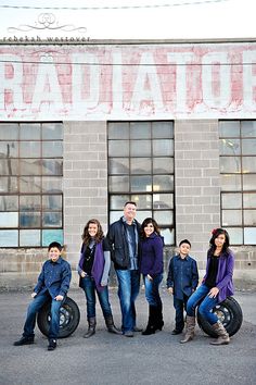 a group of people standing next to each other in front of a building