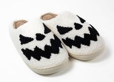 Step up your slipper game with these adorable Black & White Pumpkin Slippers! Made of soft and cozy fabric with a rubber sole, these snazzy slip-ons make a statement while keeping your feet warm. Perfect for fall festivities or just lounging around the house! Great for all genders. Details: Plush Top Sizes: 6-11 Color: black outside and pink inside. Sole: Rubber Material: Faux Fur, Fleece Lining Use: Perfect all-day use around the house. Care: Spot clean and air/hang dry. Playful Winter Slip-on Slippers, Soft Snug Slippers For Casual Wear, Soft Casual Slippers With Snug Fit, Soft Snug Casual Slippers, White Non-slip Comfortable Slippers, Casual Soft Snug Slippers, Snug Slip-on Casual Slippers, Casual Snug Slip-on Slippers, Casual Slip-on Slippers