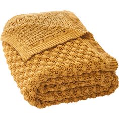 a yellow knitted blanket folded on top of each other in front of a white background