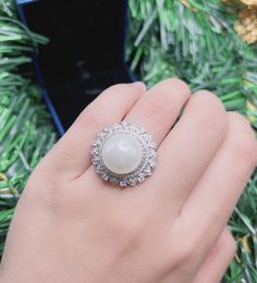 White Sea Pearl Halo Elegant Vintage Ring Pearl jewelry Stylish Ring Gift jewelry Imitation Pearl Ring jewelry Adjustable size 6-8 Exaggerated jewelry Special and unique jewelry ♥ Ready to ship ♥ The main stone is the Finest Imitation Pearl. ♥ Absolutely gorgeous and beautifully handcrafted Finest Imitation Pearl in an exquisite setting. ♥ This classic yet trendy Jewelry makes the perfect Christmas/Anniversary/Valentine's/Birthday gift for her that will be treasured forever. We have confidence t Luxury Elegant Pearl Ring With Halo Design, Luxury Halo Pearl Ring For Anniversary, Luxury White Pearl Ring With Halo, Luxury Pearl Ring With Halo Design, Exquisite Round Halo Ring Gift, Exquisite Halo Ring With Round Shape For Gift, Diamond White Pearl Promise Ring, Diamond White Round Pearl Promise Ring, Elegant Silver Opal Ring With Cubic Zirconia