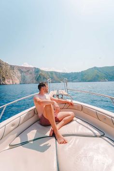 a man sitting on the bow of a boat