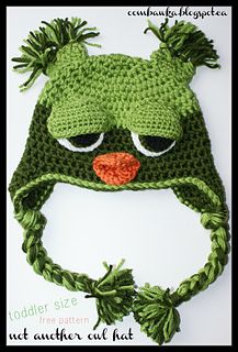 a crocheted green hat with eyes and ears