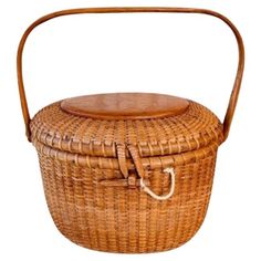 a woven basket with wooden handle on a white background