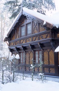 an old wooden house is covered in snow